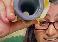 Dr. Mona Hanna-Attisha holds up lead pipe