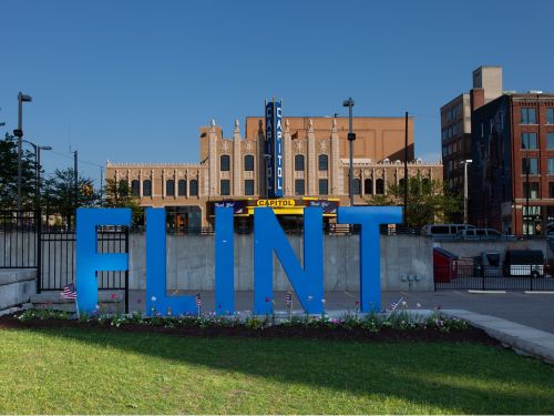 Large blue Flint sign downtown Flint on a sunny day