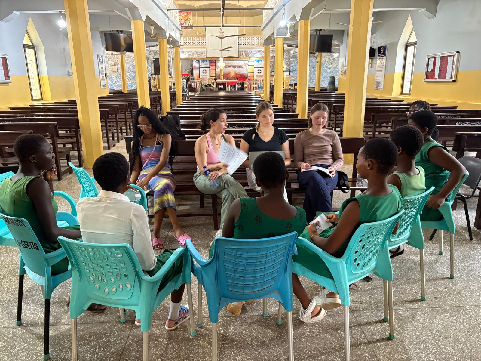 MPH Students sitting in a circle with students from Ghana