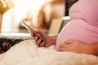 Pregnant woman using cell phone